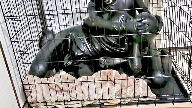 Cage - amateur rubber clad babe locked up in kinky cage bdsm