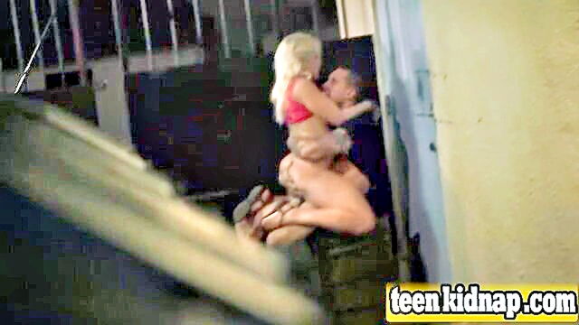 young girl restrained and in an alley