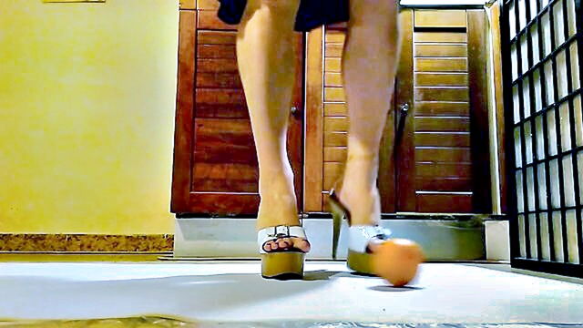redhead waitress in sexy platform heels crushes orange in homemade video : cosplay