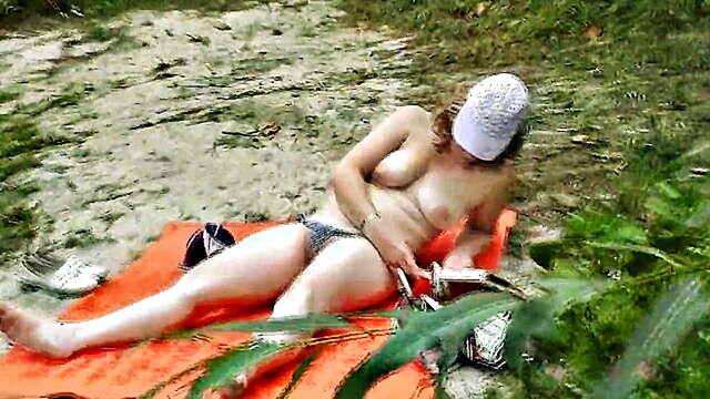 a man on a public beach unexpectedly witnesses a topless milf sunbathing by the river : FapHouse