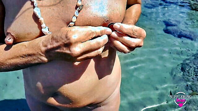 this horny milf is pissing on the nude beach while showing off her pierced pussy and wide open nipples : FapHouse