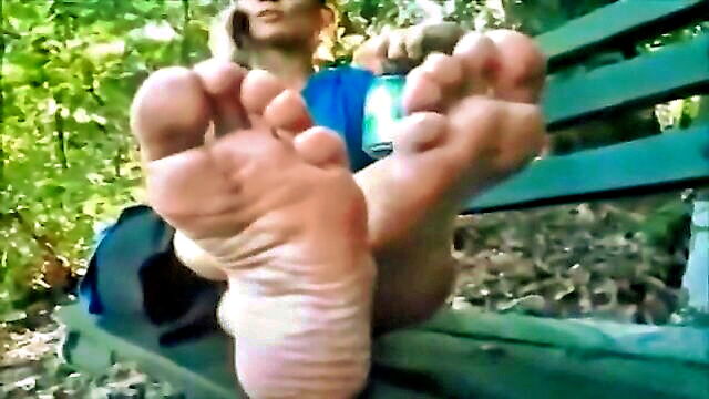 stunning girl flaunts her desirable foot soles in a park bench : angus_wunsch