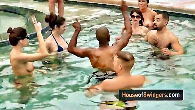 a sexy married woman enjoys swimming and flirting with group of swingers men at the pool : electa_thompson